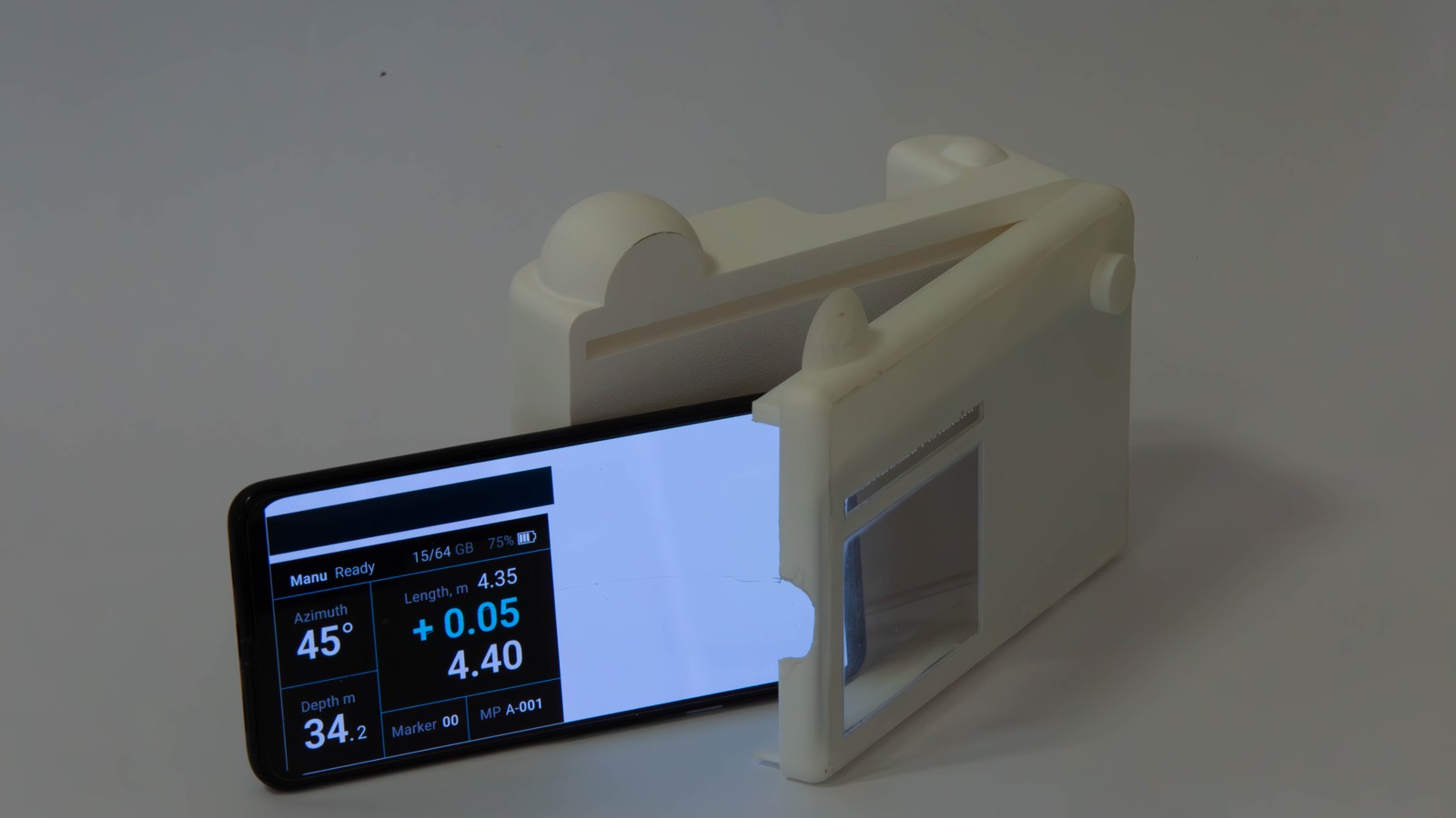 Live readout: the phone mirrors the device display.